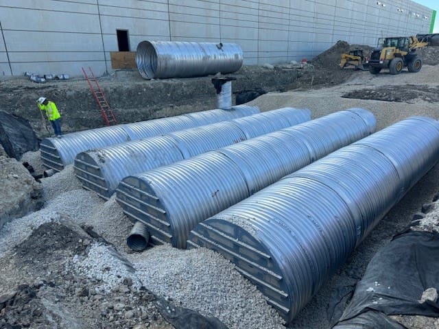 A group of pipes that are sitting on the ground.